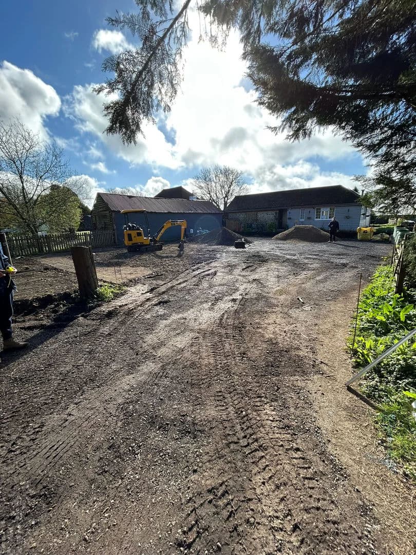 Site stripped down to formation with mini excavator on standby